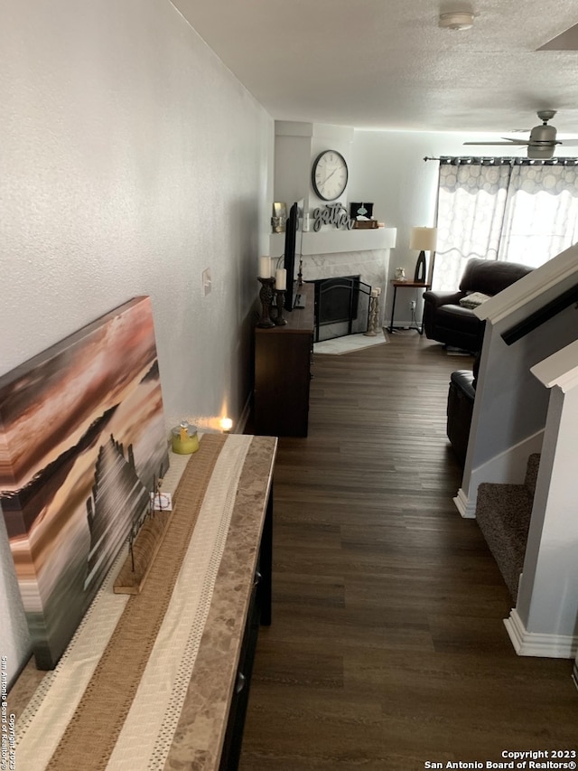 living room featuring ceiling fan and dark hardwood / wood-style flooring