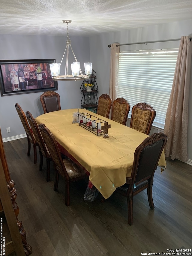 dining room featuring a chandelier, a textured ceiling, and dark hardwood / wood-style flooring