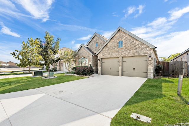 view of front of house with a front yard and a garage