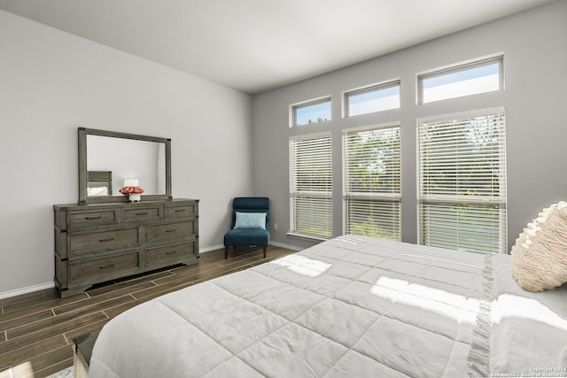 bedroom with dark hardwood / wood-style flooring