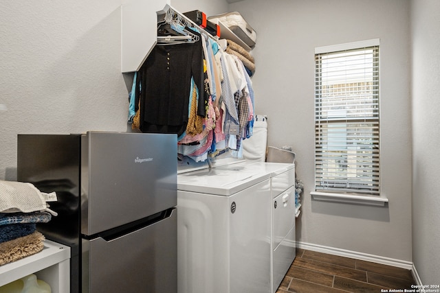 laundry area featuring washer and clothes dryer and dark hardwood / wood-style flooring