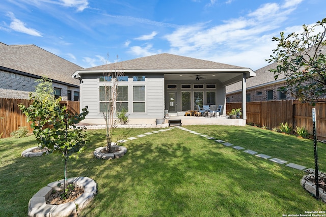 back of house featuring a patio, ceiling fan, and a lawn