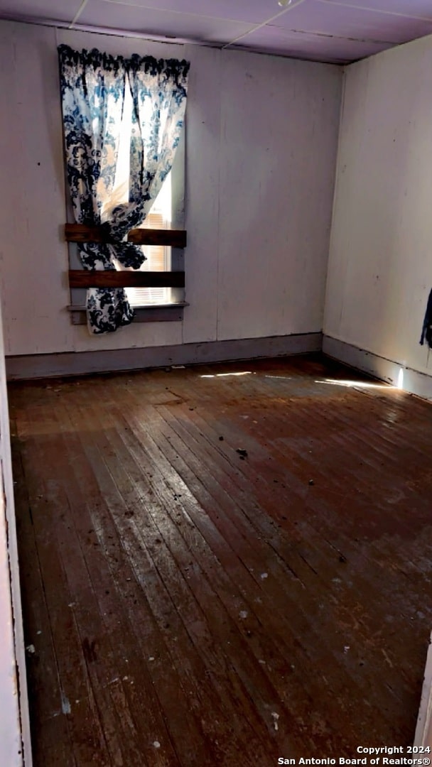 unfurnished room with wood-type flooring