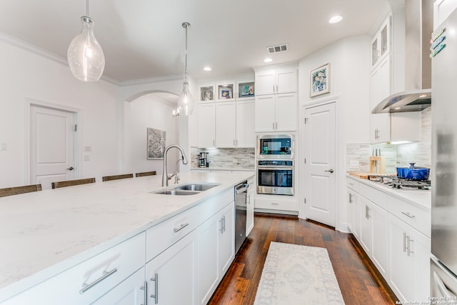 kitchen with dark hardwood / wood-style flooring, white cabinetry, sink, and wall chimney range hood