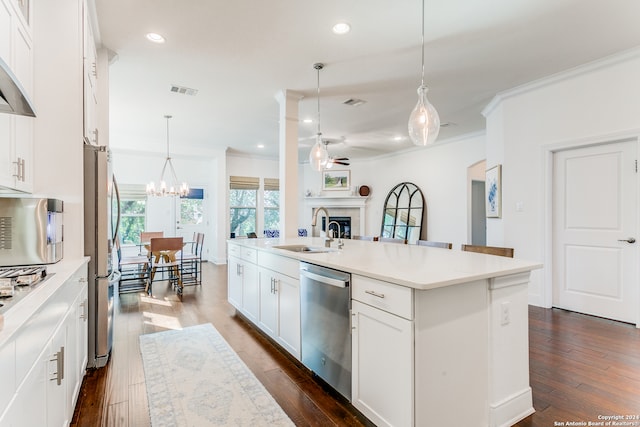 kitchen with a center island, sink, dark hardwood / wood-style floors, white cabinets, and appliances with stainless steel finishes