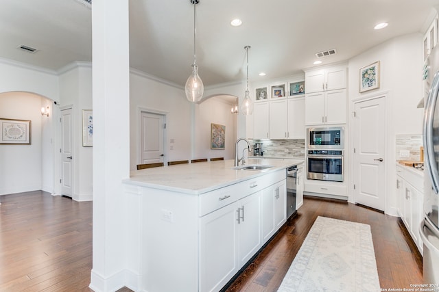 kitchen with sink, dark wood-type flooring, tasteful backsplash, light stone counters, and white cabinets