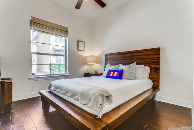 bedroom with ceiling fan and dark hardwood / wood-style flooring