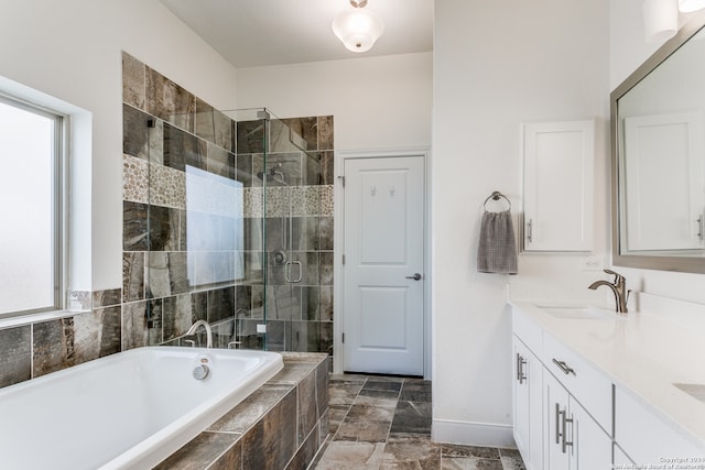 bathroom with vanity and separate shower and tub