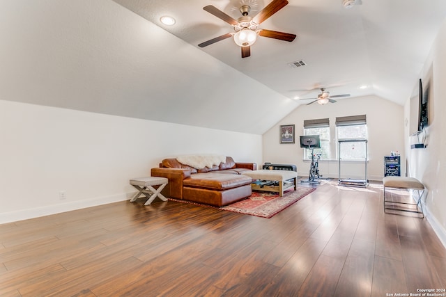 living room featuring ceiling fan, wood-type flooring, and vaulted ceiling