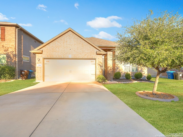 view of front of property with a garage and a front lawn