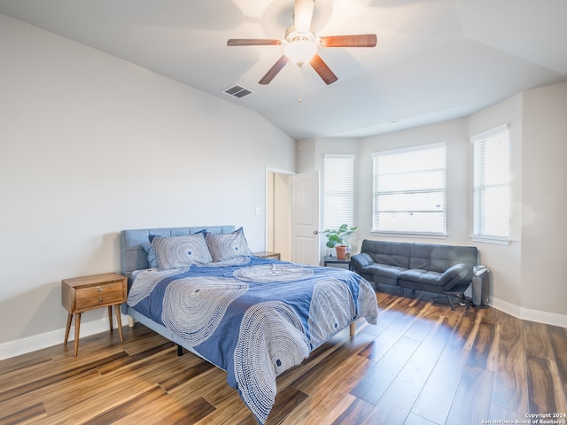 bedroom with ceiling fan, vaulted ceiling, and hardwood / wood-style flooring