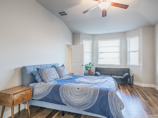 bedroom with ceiling fan, dark wood-type flooring, and vaulted ceiling