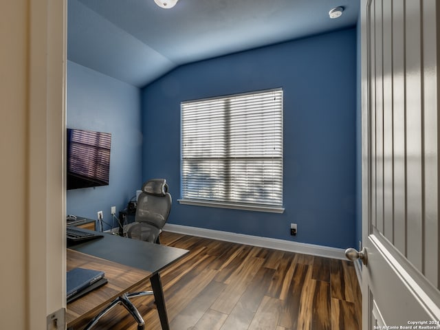 home office with dark hardwood / wood-style flooring and lofted ceiling