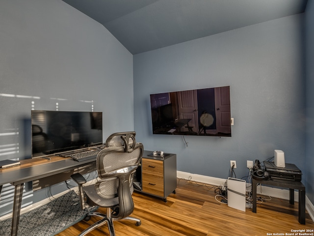 office space featuring light hardwood / wood-style flooring and vaulted ceiling