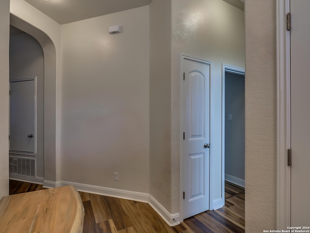 hallway with dark hardwood / wood-style flooring