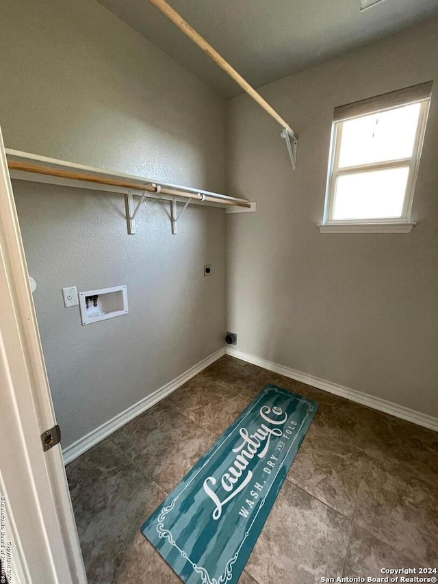 laundry area featuring hookup for an electric dryer, washer hookup, and dark tile patterned flooring