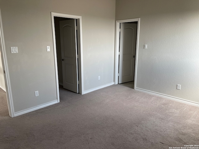 unfurnished bedroom featuring light carpet