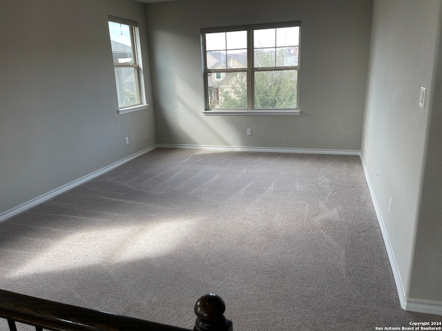 spare room with carpet and plenty of natural light