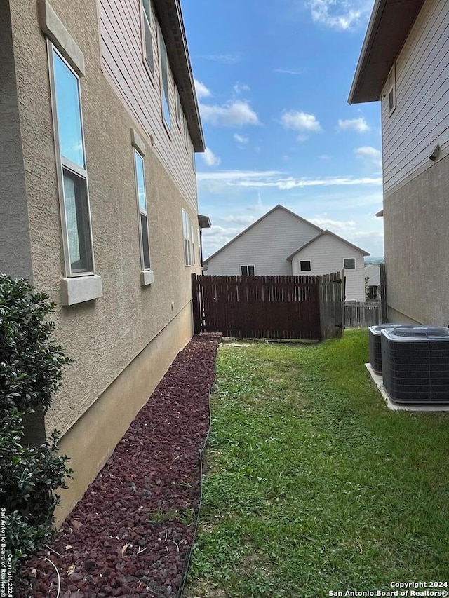 view of yard with central air condition unit