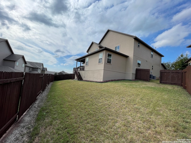 exterior space featuring a lawn and central air condition unit