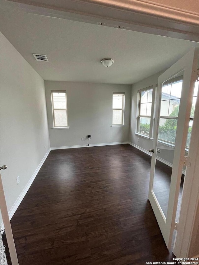 spare room with dark wood-type flooring