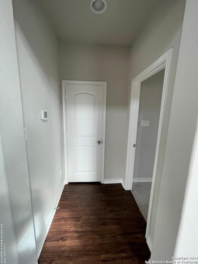 corridor with dark hardwood / wood-style floors