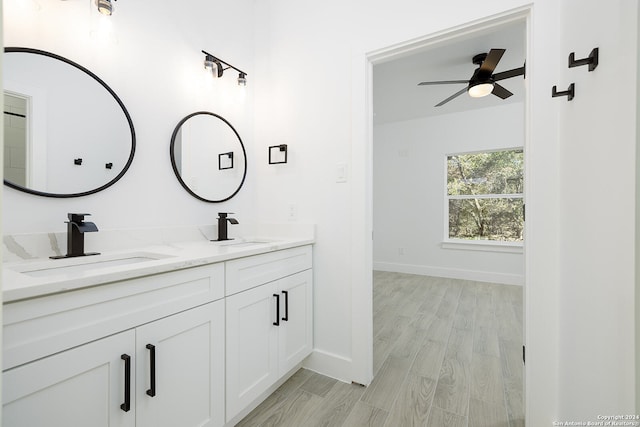 bathroom featuring vanity, hardwood / wood-style flooring, and ceiling fan