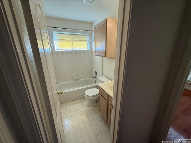 full bathroom featuring tiled shower / bath, vanity, wood-type flooring, and toilet