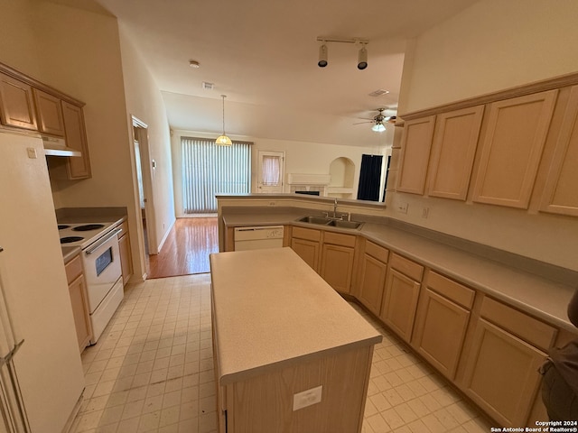 kitchen with ceiling fan, sink, light brown cabinets, white appliances, and a kitchen island