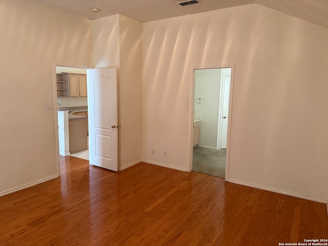 unfurnished room with high vaulted ceiling and hardwood / wood-style flooring