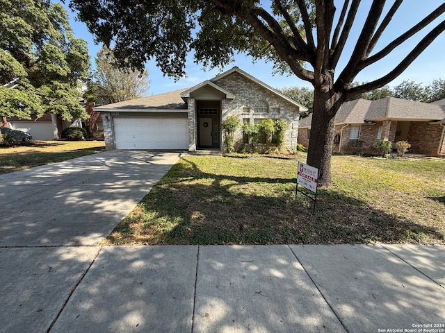 single story home with a garage and a front yard