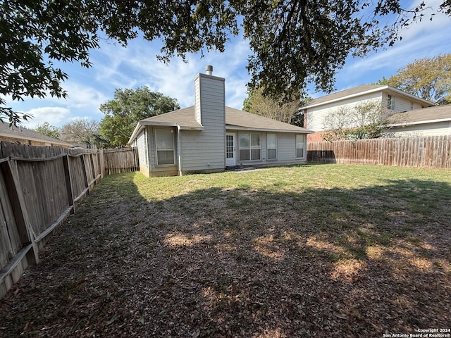 back of house with a yard