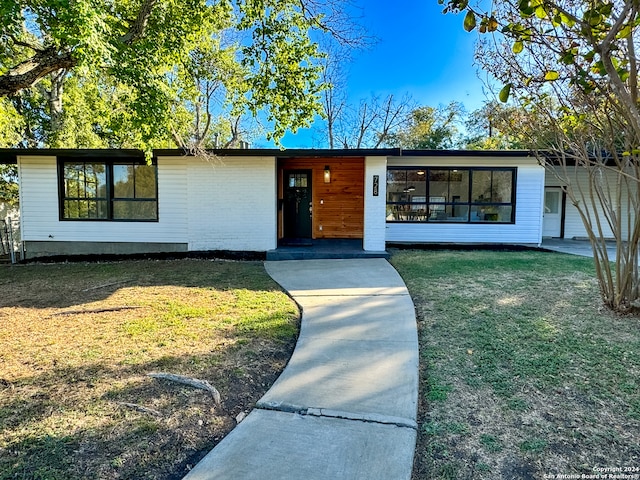 ranch-style home featuring a front yard and a carport