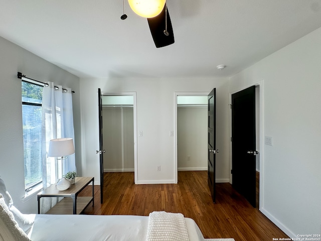 bedroom with ceiling fan and dark wood-type flooring