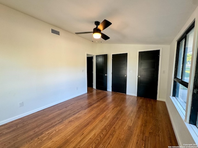 728 Rittiman, Terrell Hills, TX 78209 - unfurnished bedroom featuring multiple closets, wood finished floors, baseboards, and lofted ceiling
