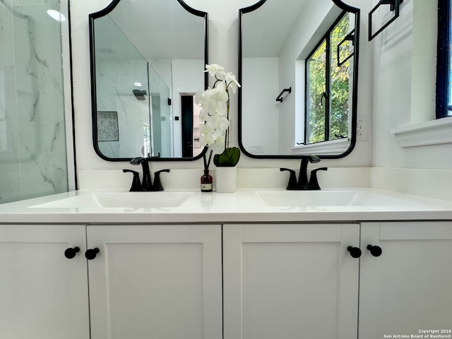 bathroom featuring vanity and an enclosed shower