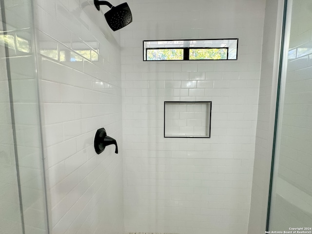 bathroom with tiled shower