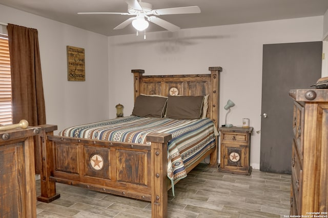 bedroom with light hardwood / wood-style floors and ceiling fan