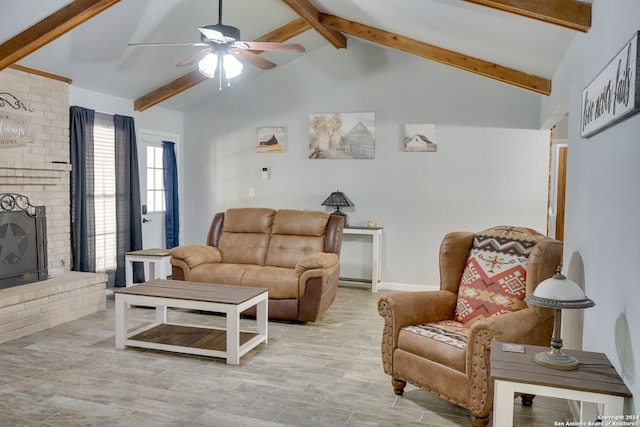 living room with a fireplace, vaulted ceiling with beams, light hardwood / wood-style floors, and ceiling fan