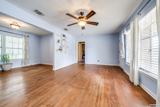 spare room featuring wood-type flooring and ceiling fan