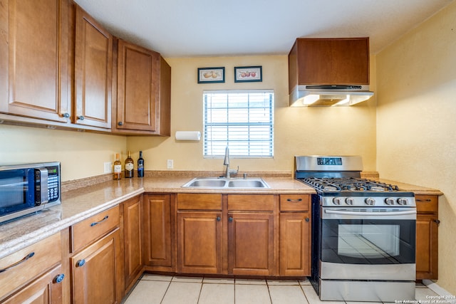 kitchen with light tile patterned flooring, sink, and stainless steel appliances