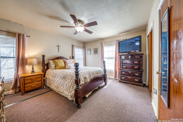 bedroom featuring carpet flooring, ceiling fan, and a textured ceiling