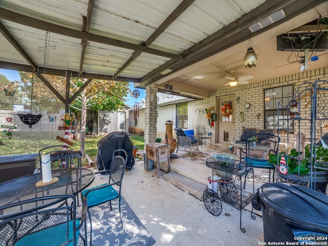 view of patio / terrace with grilling area, ceiling fan, and a storage unit