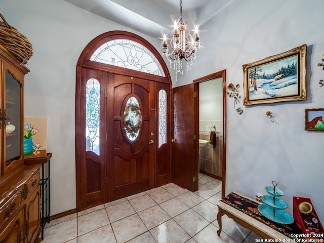 tiled entrance foyer featuring a chandelier