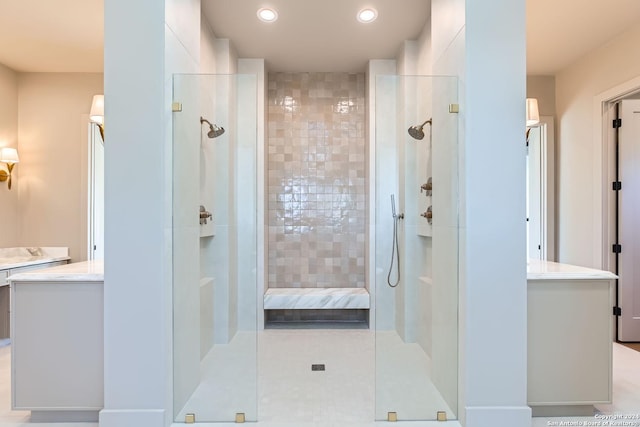 bathroom featuring tile patterned flooring, vanity, and walk in shower