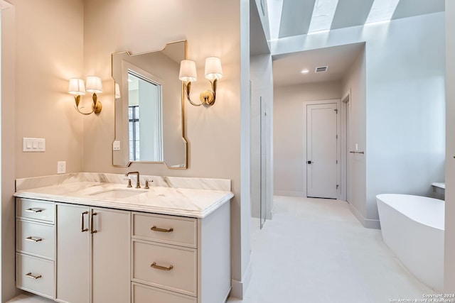 bathroom with a tub and vanity