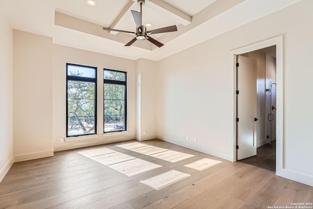 spare room featuring ceiling fan, beam ceiling, and light wood-type flooring