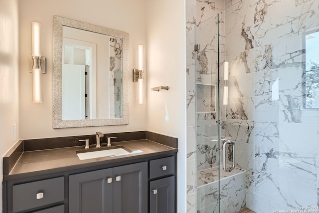 bathroom featuring vanity and an enclosed shower