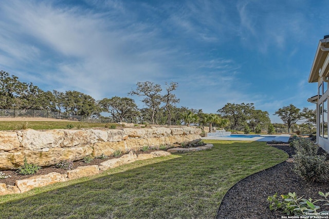 view of yard featuring a fenced in pool