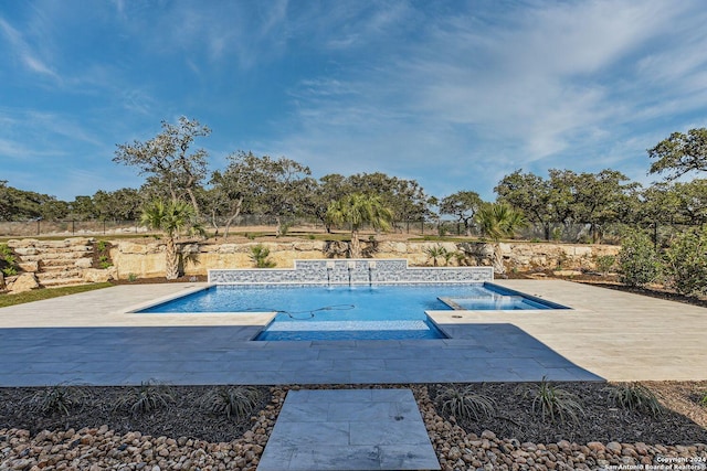 view of swimming pool featuring pool water feature and a patio area